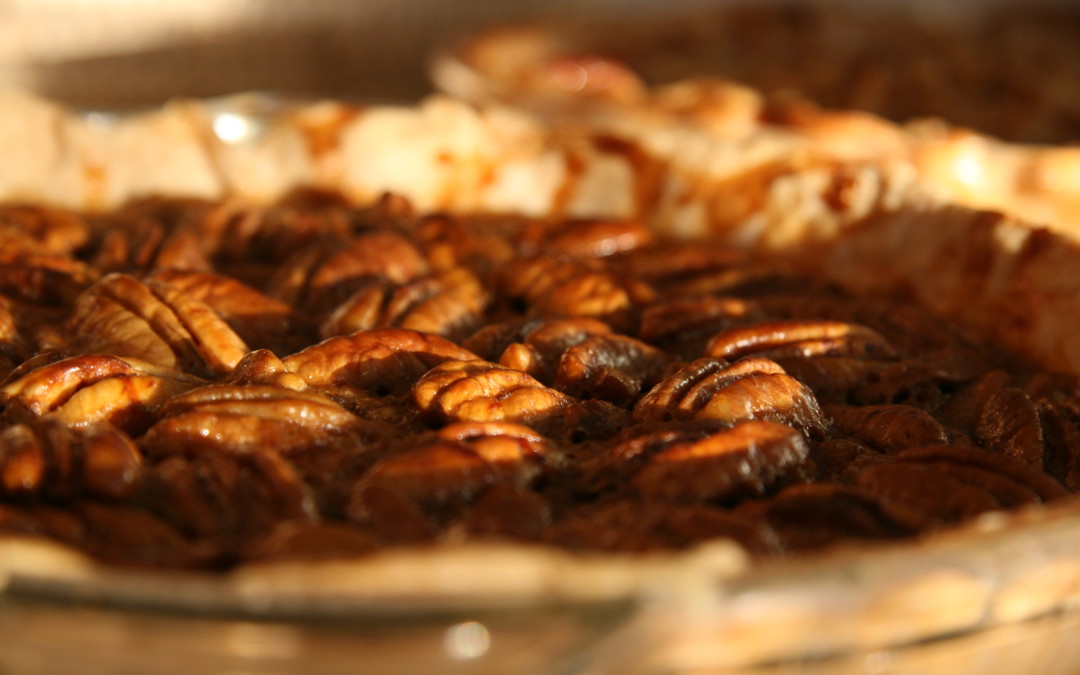 A closeup photo of a pecan pie. It looks delectable.